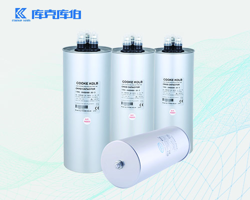 补偿电力电容器为什么会出现鼓肚的现象？